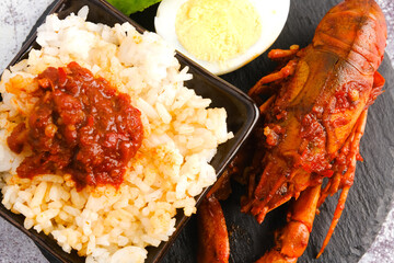 Flatlay picture of "nasi lemak" with "sambal" or spicy sauce fresh water lobster.