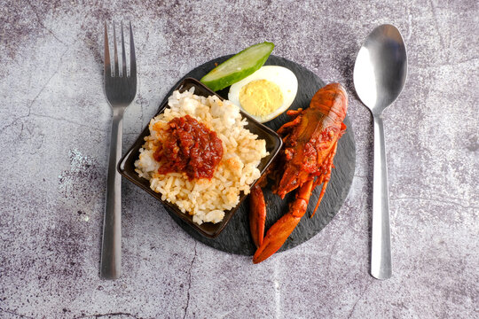 Flatlay picture of "nasi lemak" with "sambal" or spicy sauce fresh water lobster.