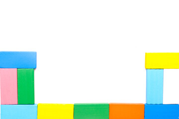 A flatlay picture of colourful wooden block arrange on isolated white background.  Children education and development concept.