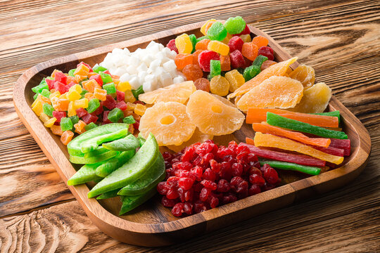 set of dried berries and fruits on a wooden plate