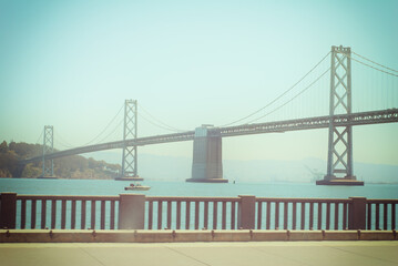 San Francisco-Oakland Bay Bridge on a sunny day in San Francisco, California, USA. Color filter and vignette applied.