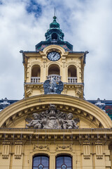 Fototapeta na wymiar sculpture on the building and clock tower, Szeged, Hungary