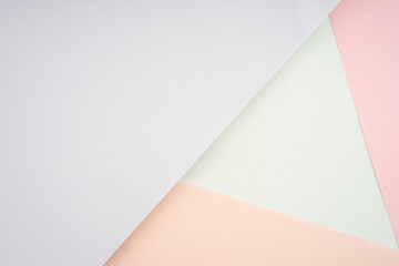 Creative arrangement of soft pastel colored papers creating an abstract background