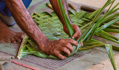 Hands Sewing Roof by Thatching Green Leaves