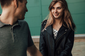 young fashionable in love beautiful couple shopping and having fun near the supermarket ride on a trolley