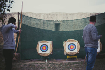 Peoples practicing archery in park