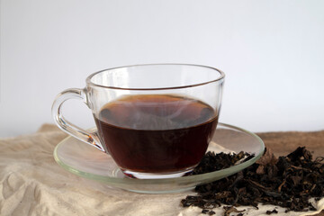 Tea in a clear cup and dry tea