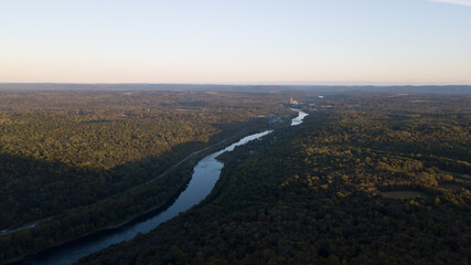 Drone shot of Delaware water gap PA river national park during summer fall foliage with sunset on the side of forest mountain 