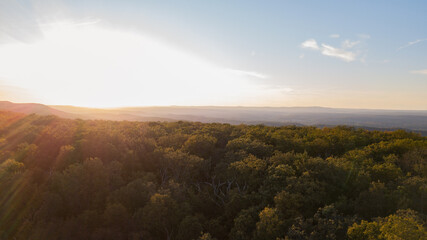 Drone shot of Delaware water gap PA river national park during summer fall foliage with sunset on the side of forest mountain 