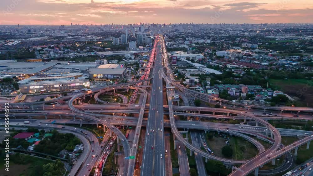 Wall mural Time lapse Aerial view and top view of traffic on city streets in Bangkok , Thailand. Expressway with car lots. Beautiful roundabout road in the city center. - Wall murals