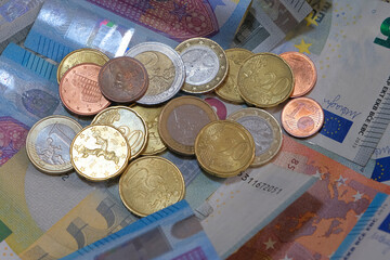 multiple euro banknotes and coins
