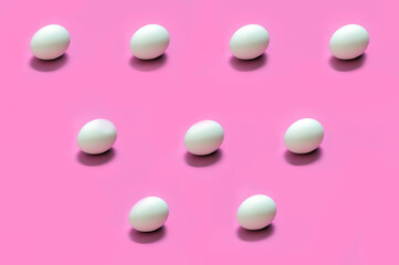 Abstract eggs arranged on solid color background