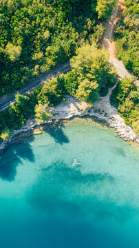 Aerial view of people swimming in blue lake on Mljet National Park, an island in Croatia © Alexx