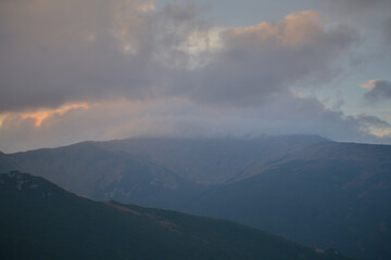 Fototapeta premium Beautiful sunrise view of landscape of mountains, forest and meadows in the Carpathians in sunny cloudy weather