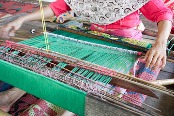 traditionally makes yarn with a spindle wheel at traditional Sasak village, Desa Sasak Sade, Lombok Indonesia.