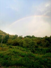 Naklejka premium rainbow over the mountains