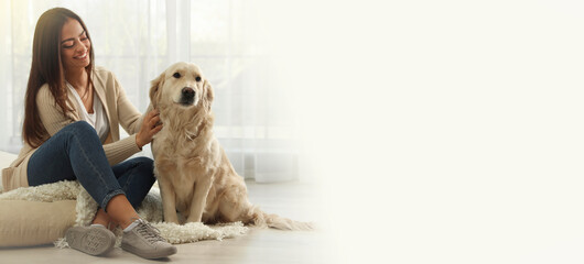 Young woman with her pet at home, space for text. Banner design