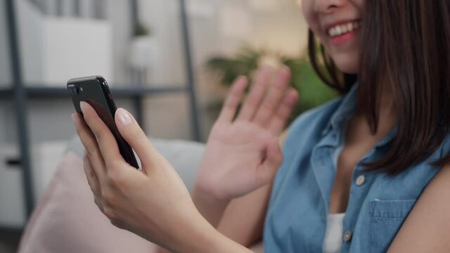 Close Up Of Young Asian Woman's Hand Waving Making Video Calling On Smartphone Video Call Chat With Friends Or Family On A Mobile Phone At Home. Asia Female Video Conference Working With A Colleague