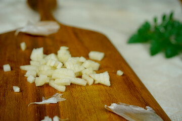 finely sliced garlic on wooden board