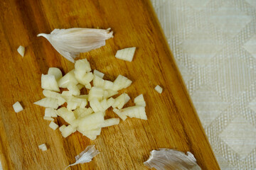 finely sliced garlic on wooden board background