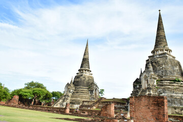 Fototapeta premium The ruins of old pagoda made from brick isolated with beautiful sky and clouds.