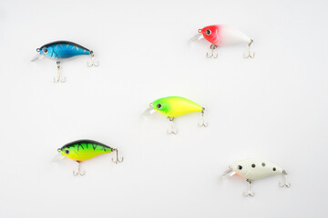Creative arrangements of wobbler lures. Fishing lure with hooks. Plastic fish with hooks. Flat lay or top view.