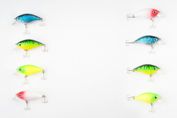 Creative arrangements of wobbler lures. Fishing lure with hooks. Plastic fish with hooks. Flat lay or top view.