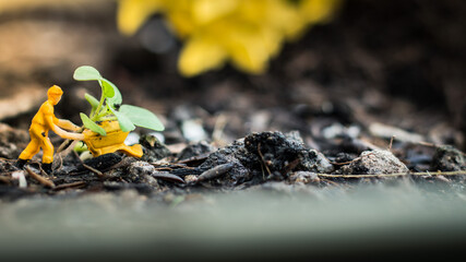 Miniature people team works to inspect and plant trees for a green world project. (We plant trees for a better world)