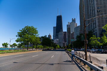 Fototapeta na wymiar Chicago Downtown Skyline from Empty Lake Shore Drive Road on Sunny Cloudless Day