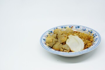 Indonesian traditional meatballs or bakso. Soup containing meatballs, eeg, noodles isolated on white background