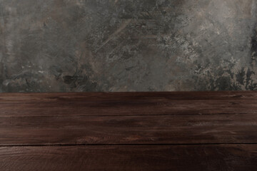 Image of wooden table in front of blurred background. Empty wooden table platform over background for present product.