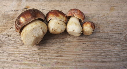 Edible peeled mushrooms lie on wooden background, top view          