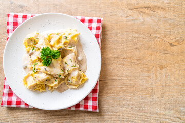 tortellini pasta with mushroom cream sauce and cheese