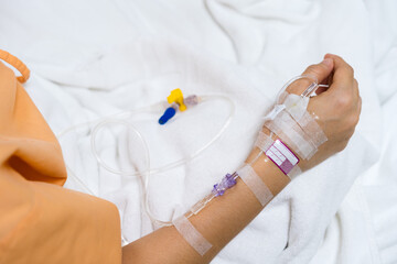 patient hand in hospital with a saline