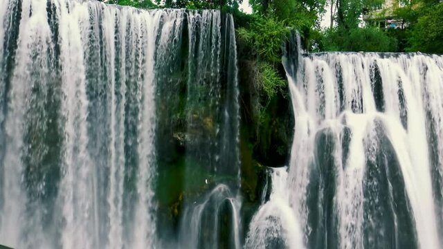 Big mountain river Pliva waterfall rich of water during spring time.