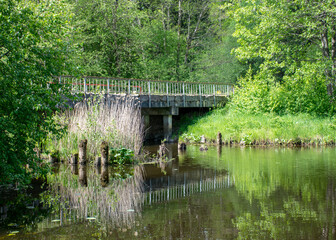 summer landscape with an old concrete bridge over the river