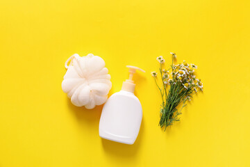 Shower gel with bast wisp and chamomile flowers on color background