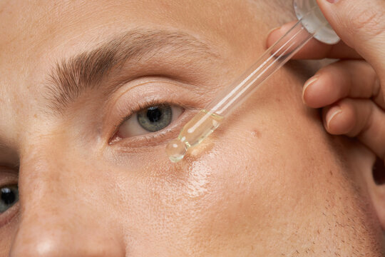 Men's skin care. Close-up facial procedure for a model. Vitamins for the restoration and renewal of the face.