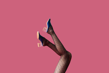 Legs of beautiful young woman in tights on color background