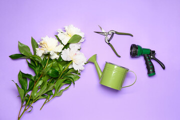 Set of gardening supplies with flowers on color background