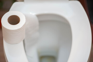 Little boy teen use tissue paper clean in toilet