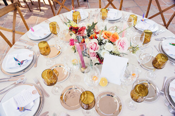 Table serving of tropical wedding with candles, fruits, menu and alebrije