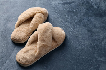 Fototapeta na wymiar Pair of soft slippers on grey background