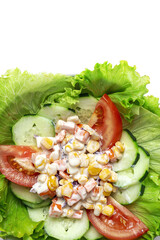 Fresh lettuce salad with tomatoes, red onion, corn, carrots, cucumber