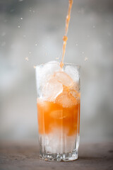 freshly squeezed grapefruit juice with ice in a tall glass