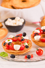 Friselle with tomatoes and mozzarella cheese.
