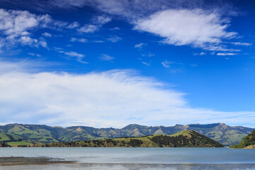 Landscape on Banks Peninsula, New Zealand. Cloudscape over Akaroa Harbour and Onawe Island