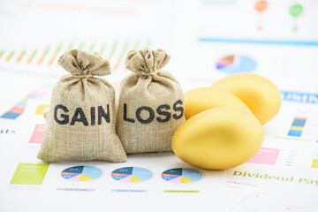 Capital investment gain and loss, financial concept : Gain and loss bags, golden eggs on summary reports, depicts managing profit and loss while investing in assets e.g bonds, stock, derivatives, ETFs