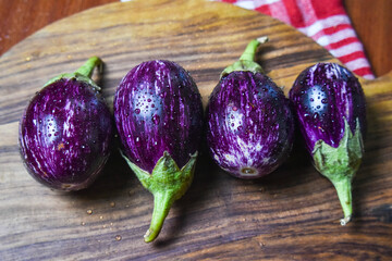 fresh brinjal on wood chopping board for vegetables