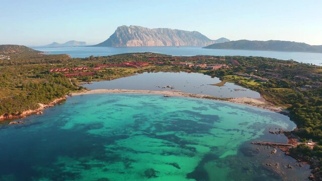 4K aerial - a bird's eye view&nbsp;video (Ultra High Definition). Astonishing summer scene of Salina Bamba beach with Tavolara mountain on background. Spectacular morning view of Sardinia island, Italy.